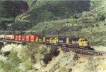 Heavy eastbound stack train comes up the grade.